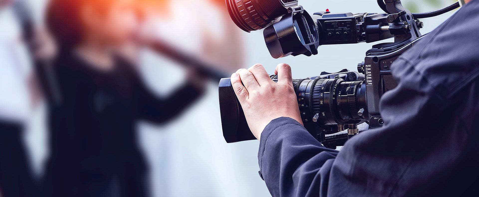 Detail closeup of a camera person holding film equipment